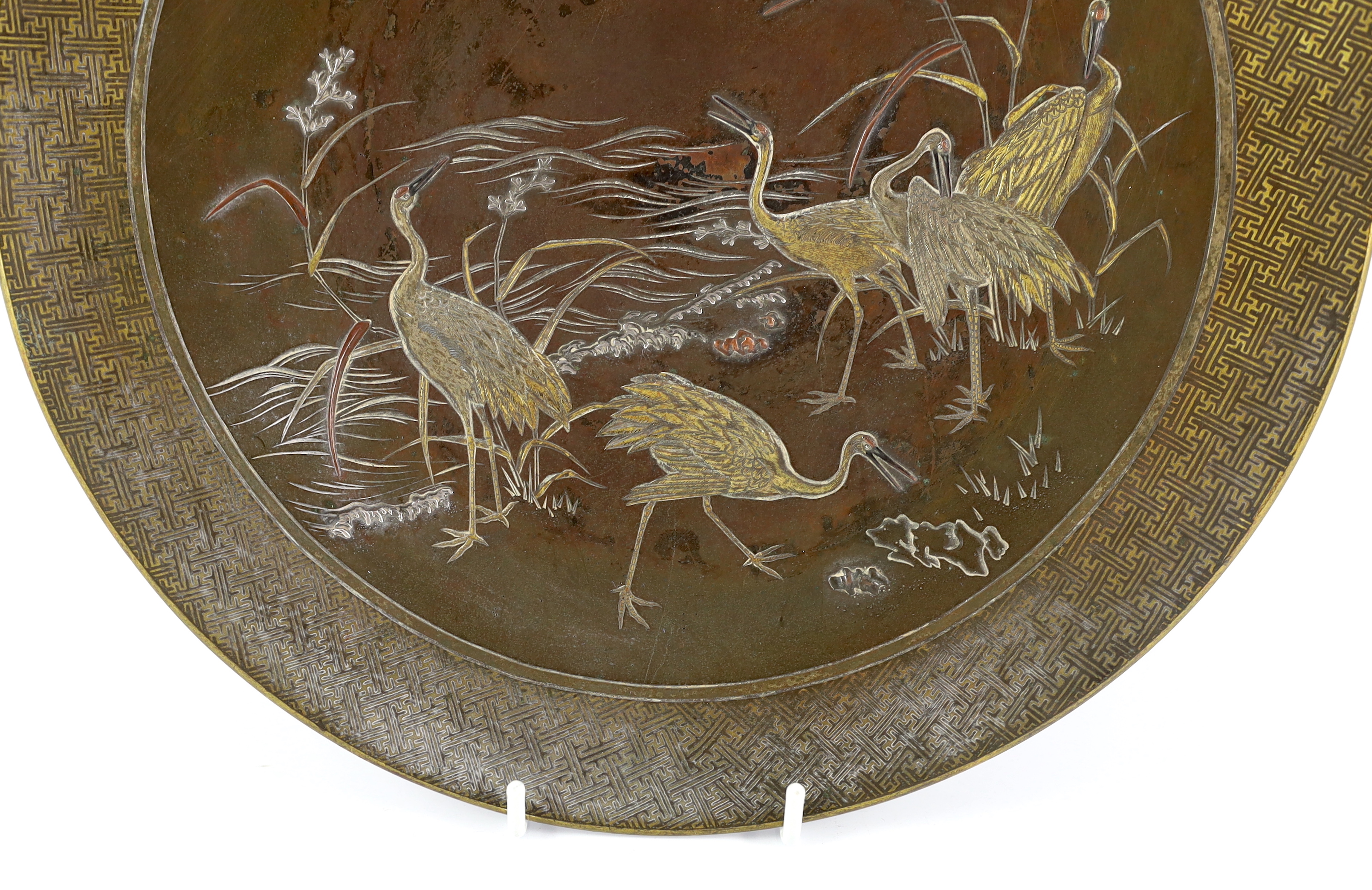 A Japanese Komai style mixed metal inlaid bronze dish, Meiji period